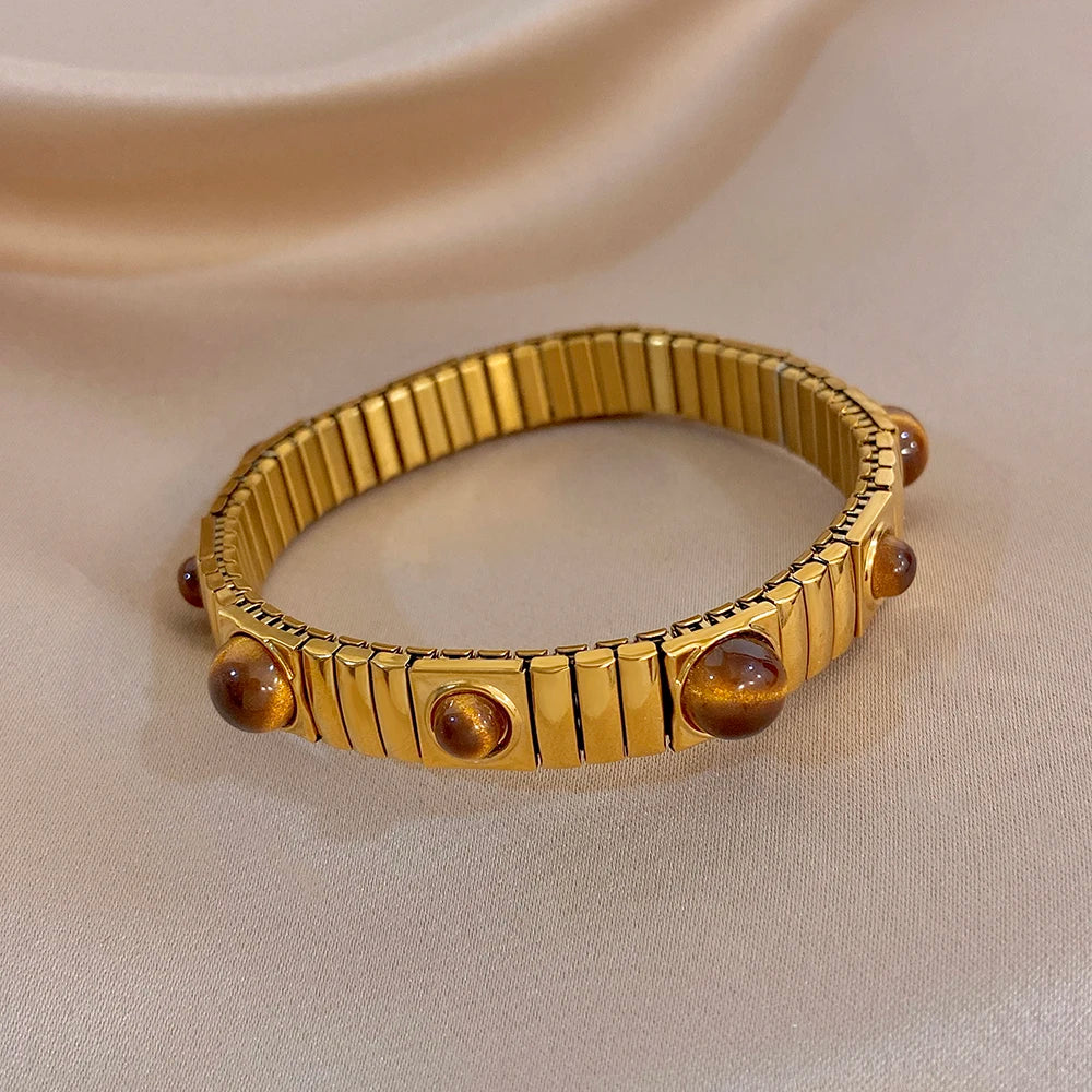 צמיד זהב גמיש עם אבנים חומות עגולות